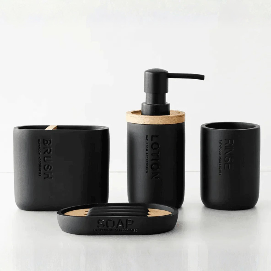 Black bathroom vanity accessories including soap dispenser and toothbrush holder