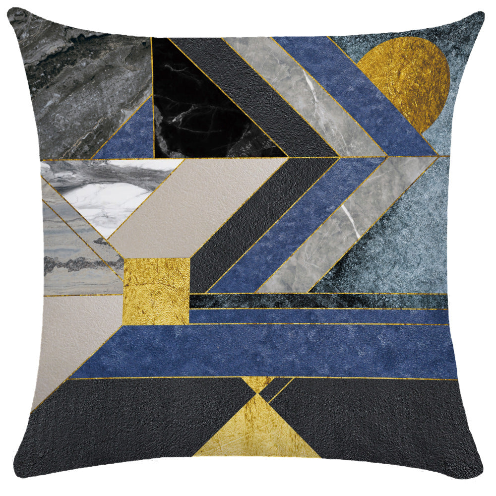 Multi-texture geometric collage pillow cover featuring navy, black, beige leather, and gold foil