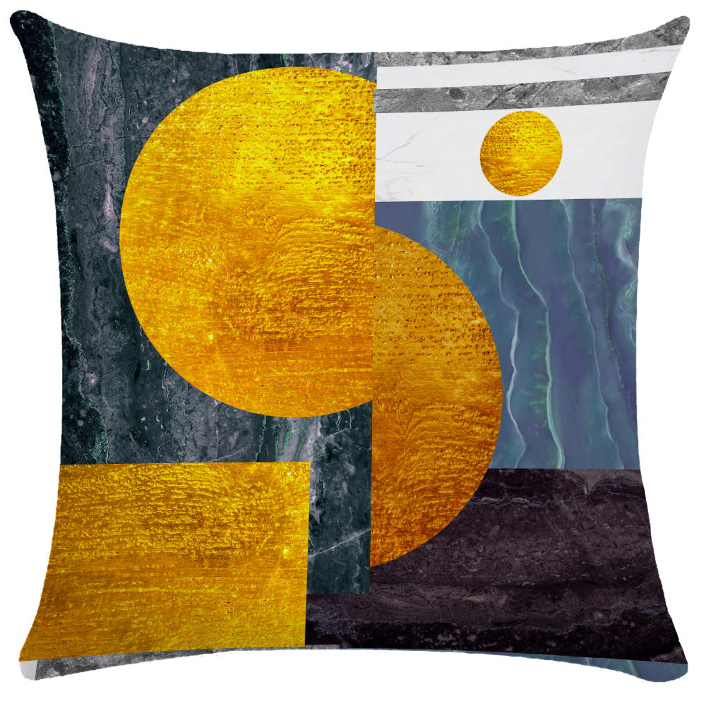 Dark textured pillow cover with large gold circle and teal-blue wavy marbled section