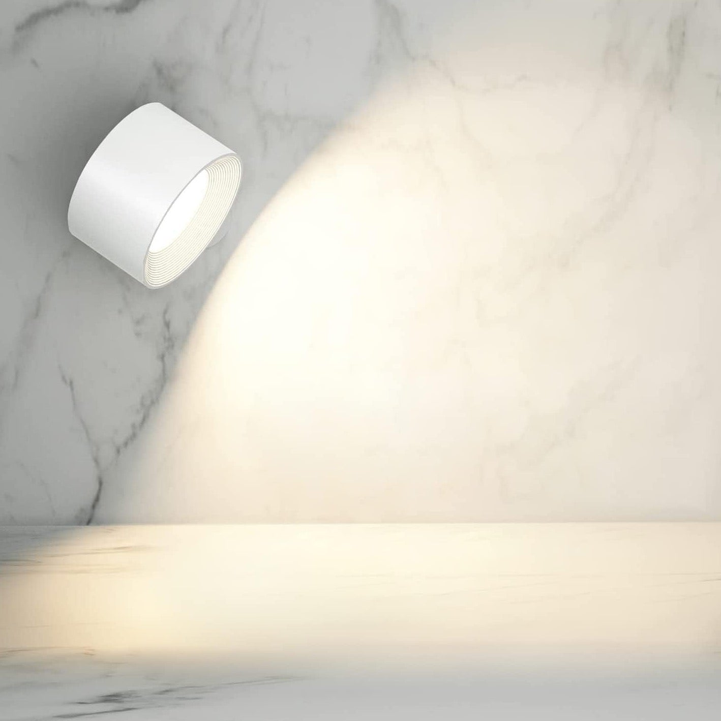 Directional white wall light casting warm cone beam on marble surface