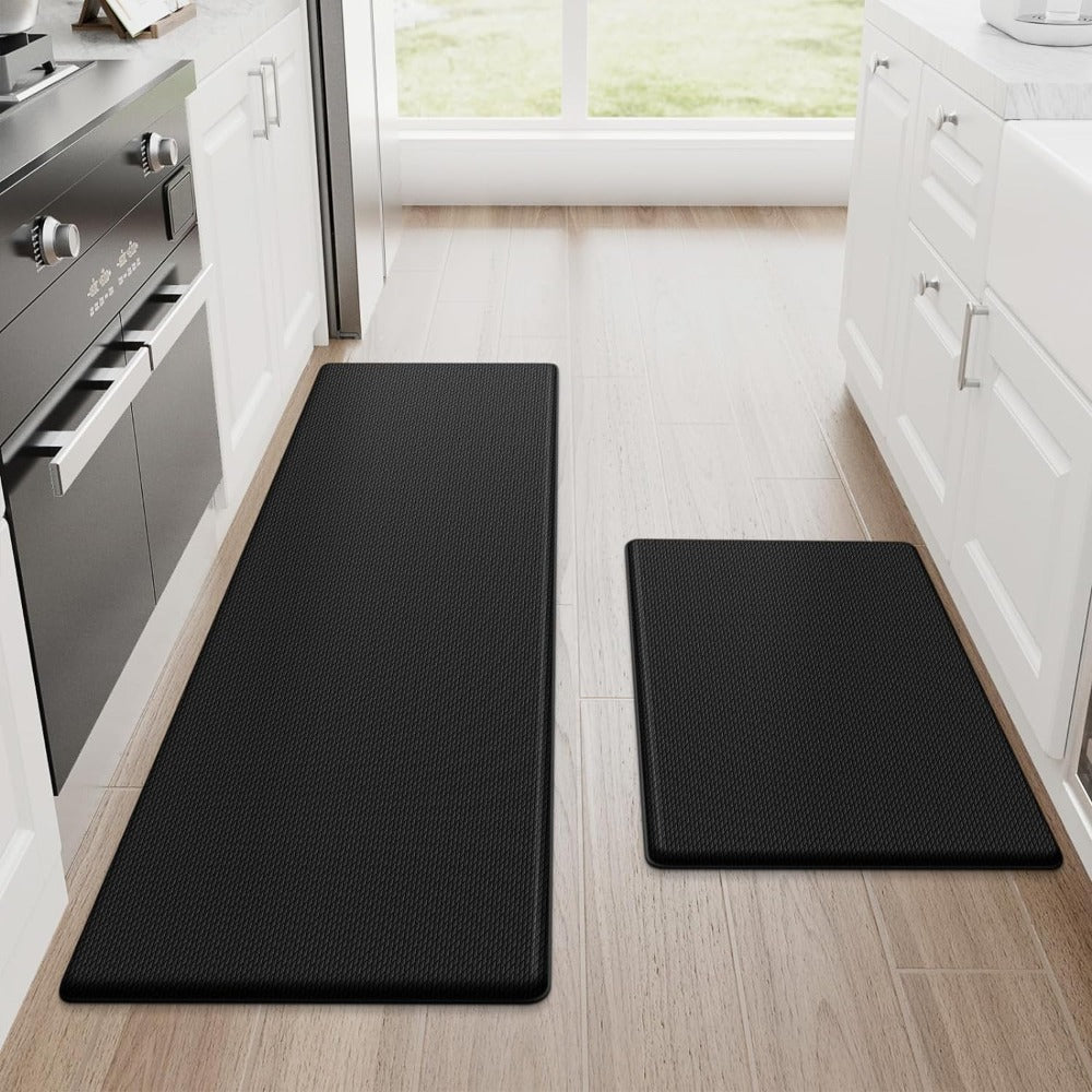 Black kitchen mat set with subtle grid pattern on light wood flooring