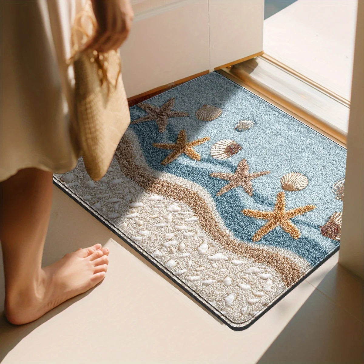Beach theme bath mat with starfish and seashell print on textured microfiber