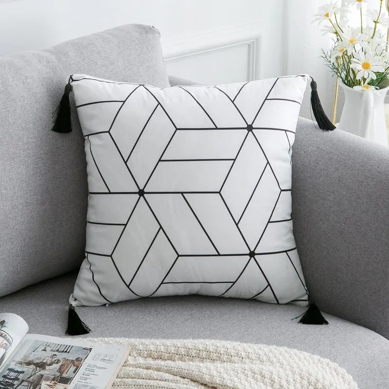 Line-art geometric polygon cushion with dot details and corner tassels