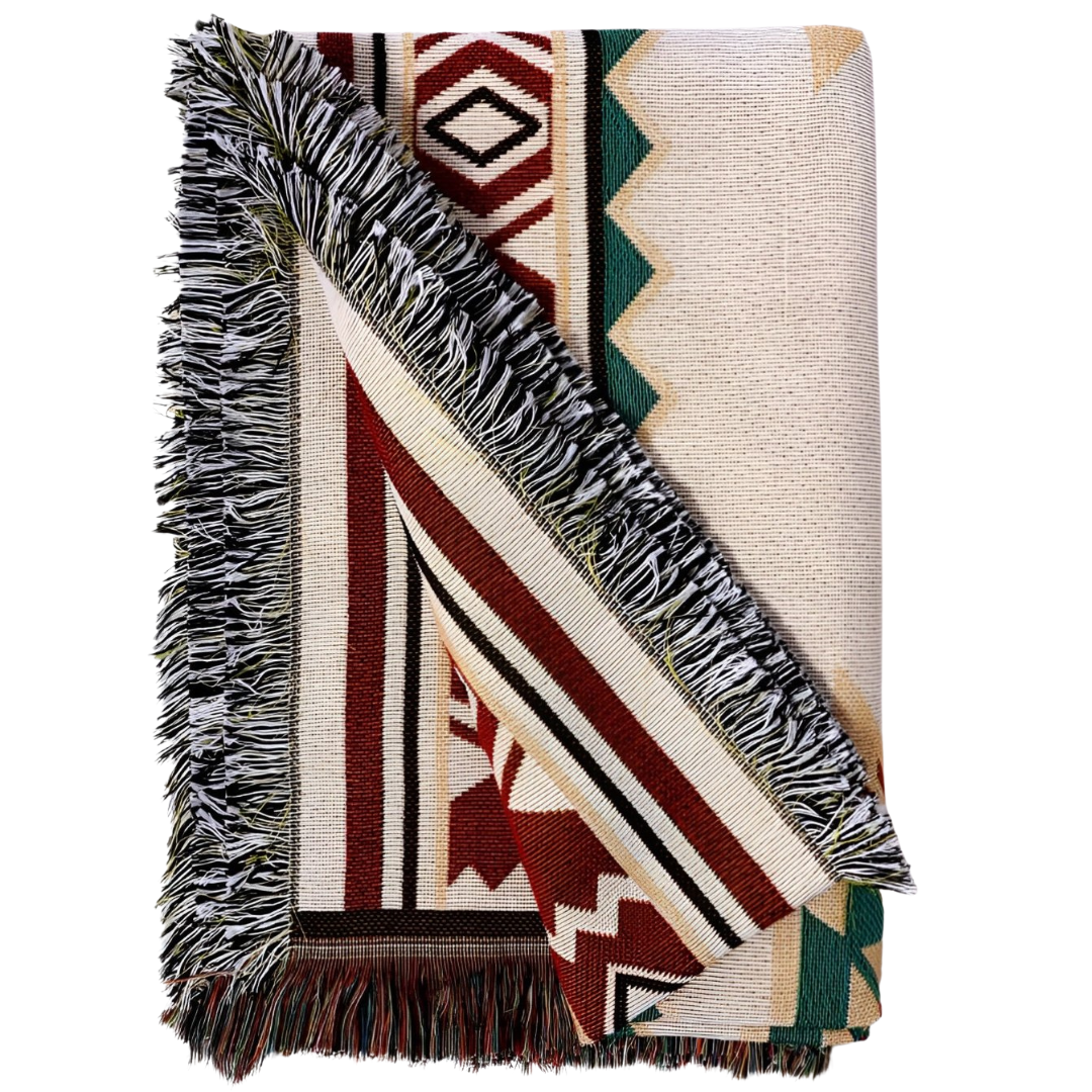 Folded boho woven picnic blanket with Southwestern geometric pattern and fringe