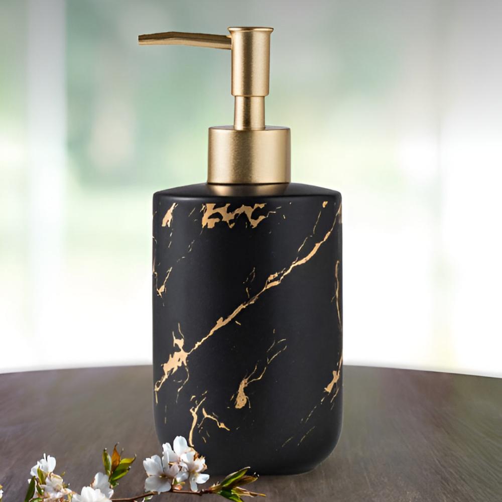 Matte black ceramic soap dispenser with gold veins on dark wood with white flowers