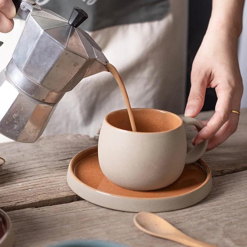 Pouring coffee into orange-brown interior ceramic espresso cup and saucer set