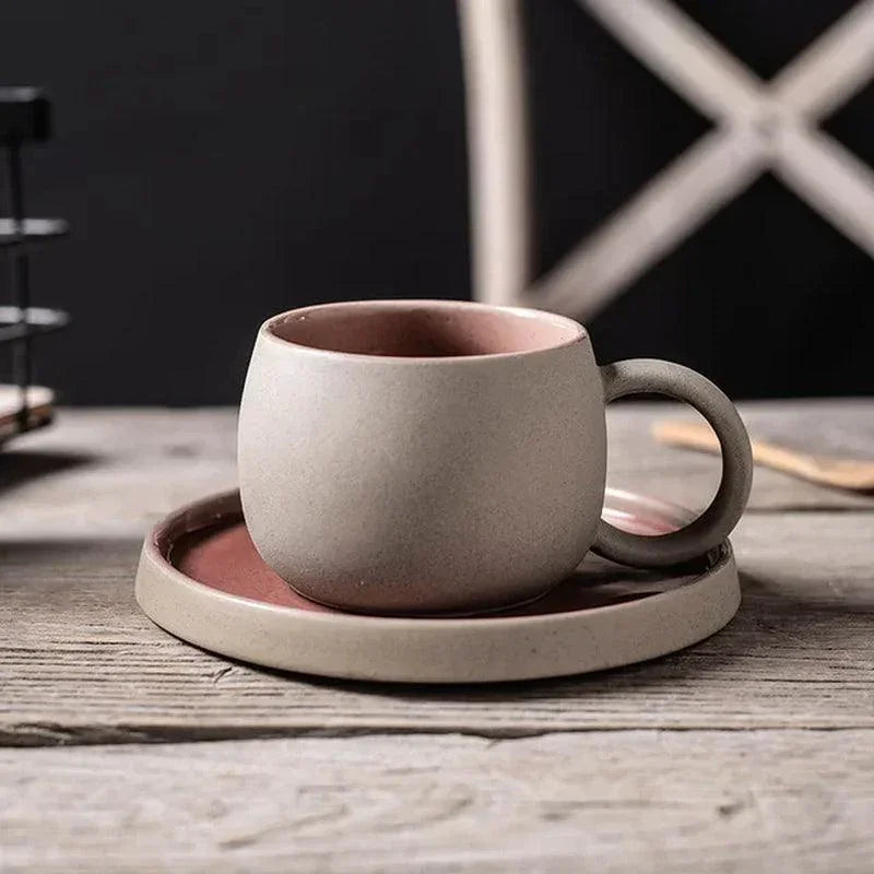Speckled matte stoneware espresso cup and saucer set with earthy pink interior