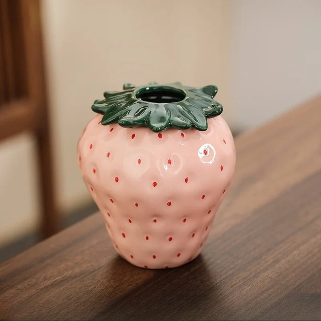 Glossy pink ceramic strawberry vase with green leaf top and seed details