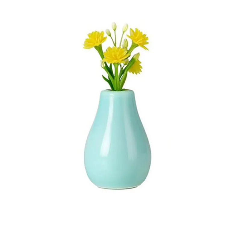 light blue teardrop ceramic magnet vase with yellow flowers