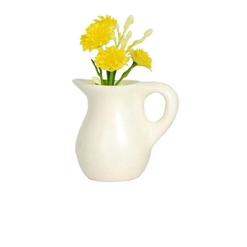 white ceramic pitcher magnet vase with curved spout and yellow chrysanthemums
