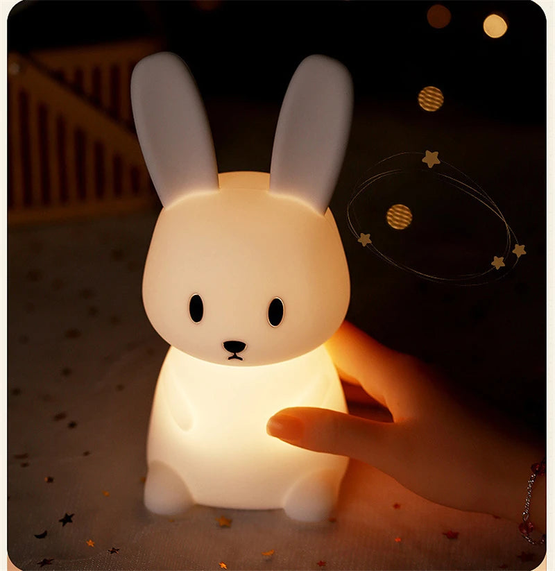 Interactive rabbit night light with star confetti and warm yellow glow