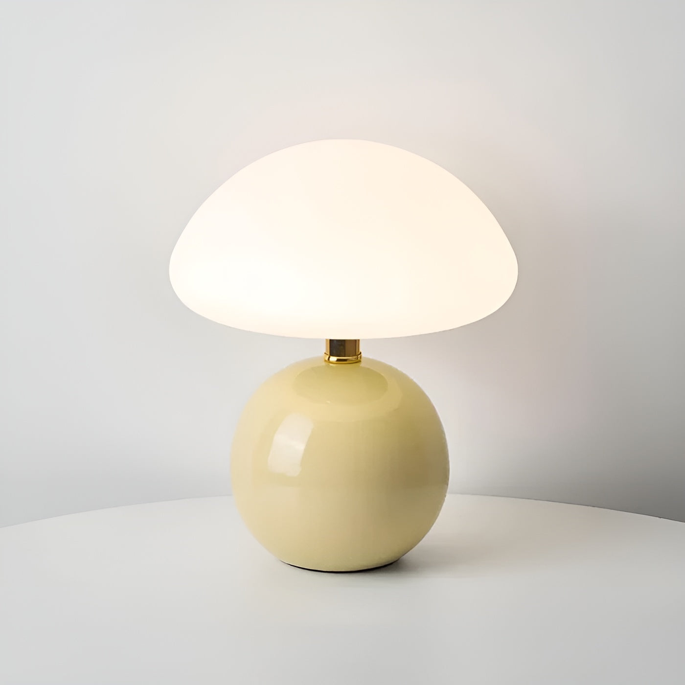 Pale yellow compact table lamp with thin gold metallic collar