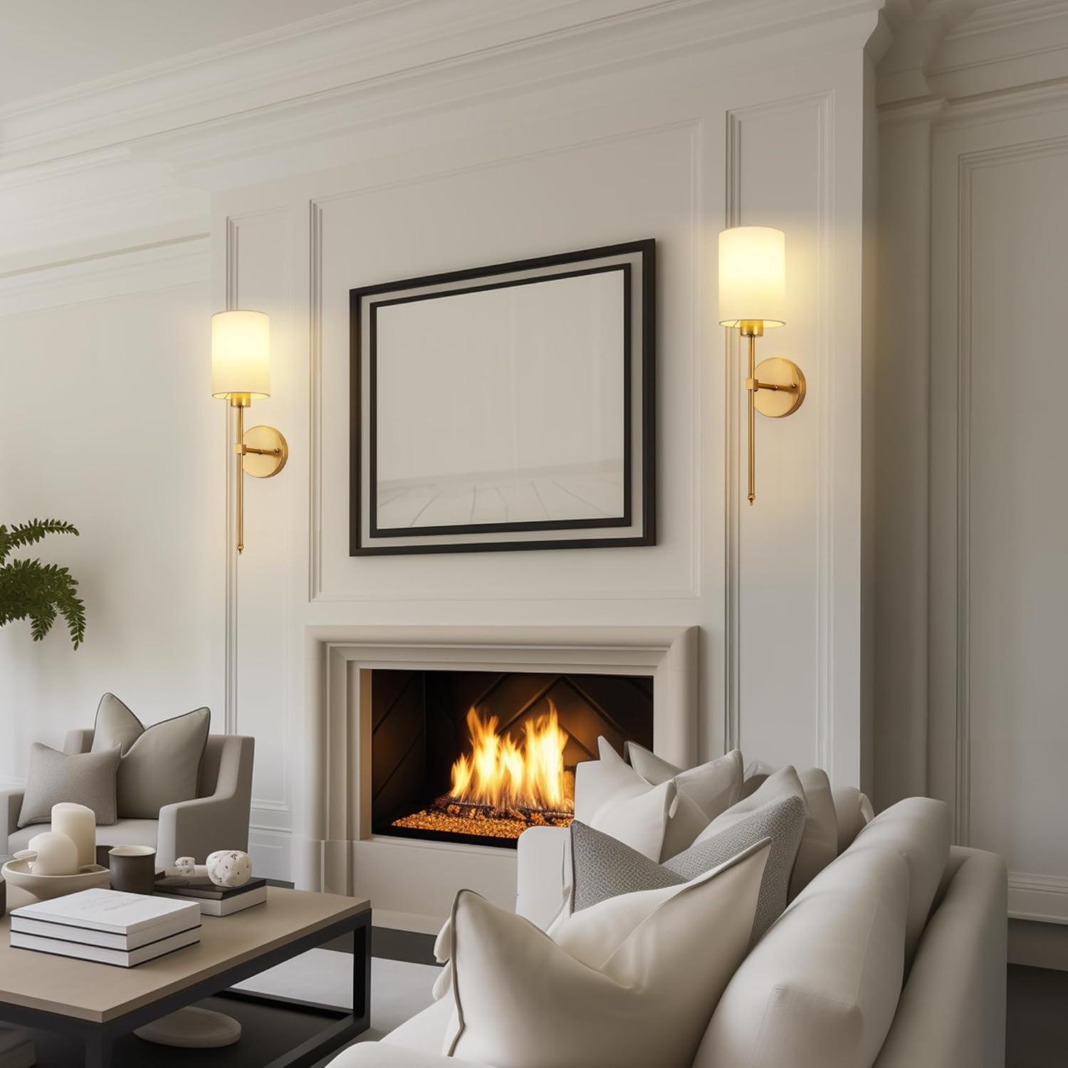 Set of 2 gold wall sconces with white fabric shades above fireplace