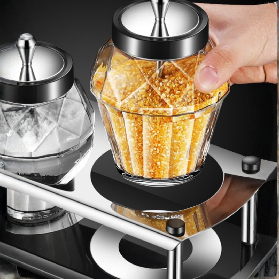 Close-up of diamond-cut glass sugar jar with stainless steel lid and internal spoon on metal rack