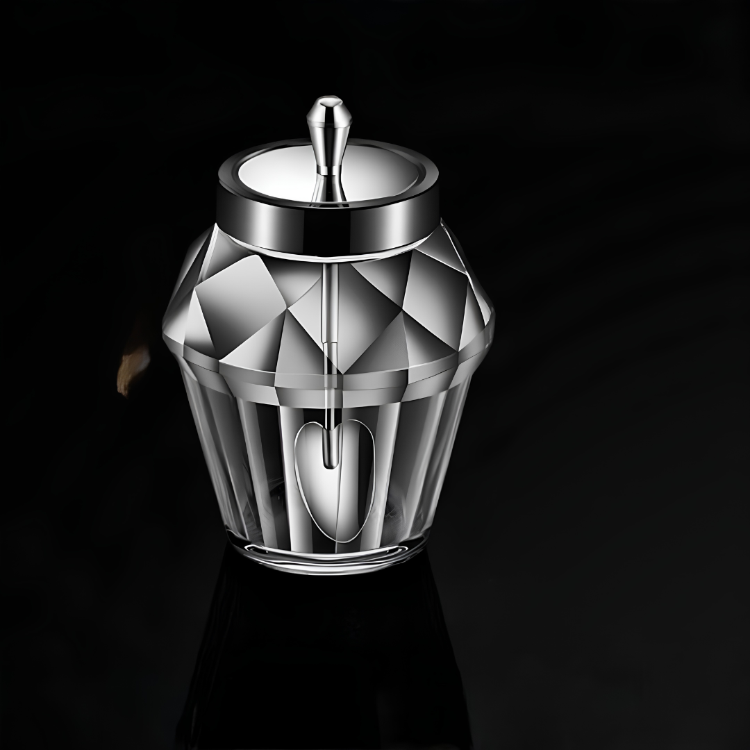 Single diamond-patterned glass spice jar with heart-shaped spoon and stainless steel lid on dark surface