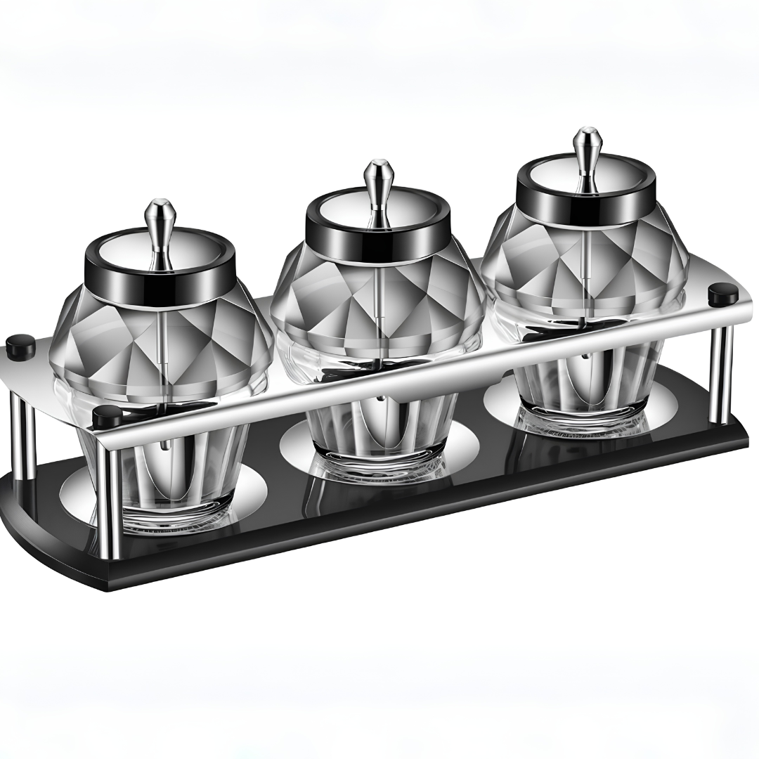 Empty 3-piece geometric diamond glass spice jars with stainless steel lids on black base rack