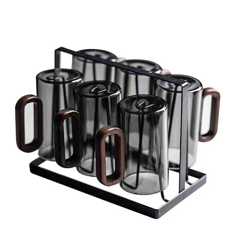 Six dark smoked glass mugs with wooden handles stored in wire rack