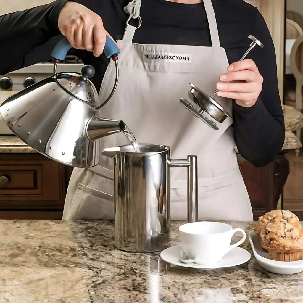 Pouring hot water into open double wall French press with mesh filter