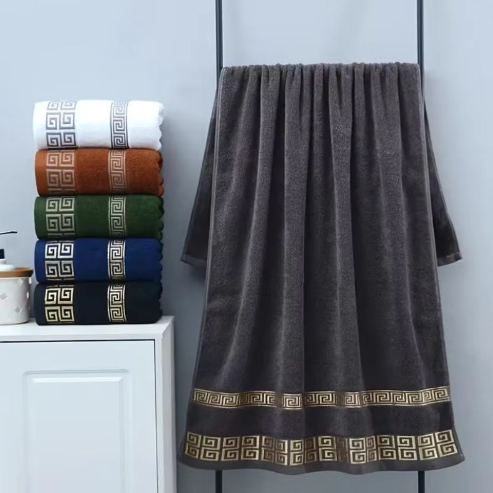 Geometric border towel set with gold Greek key embroidery on dark gray cotton
