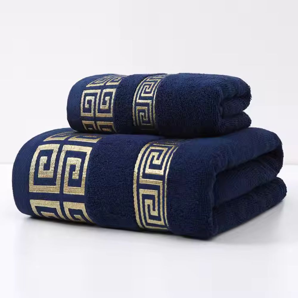 Deep navy blue towel set with gold Greek key embroidery and full terry weave