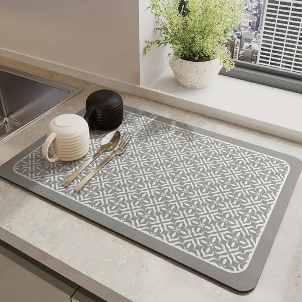 Gray silicone dish drying mat with white mandala pattern on kitchen counter