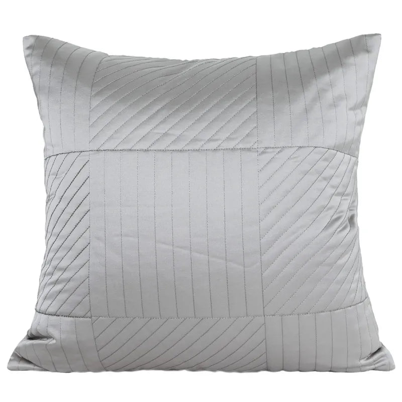 Light gray geometric stitched square decorative pillow with chevron detail