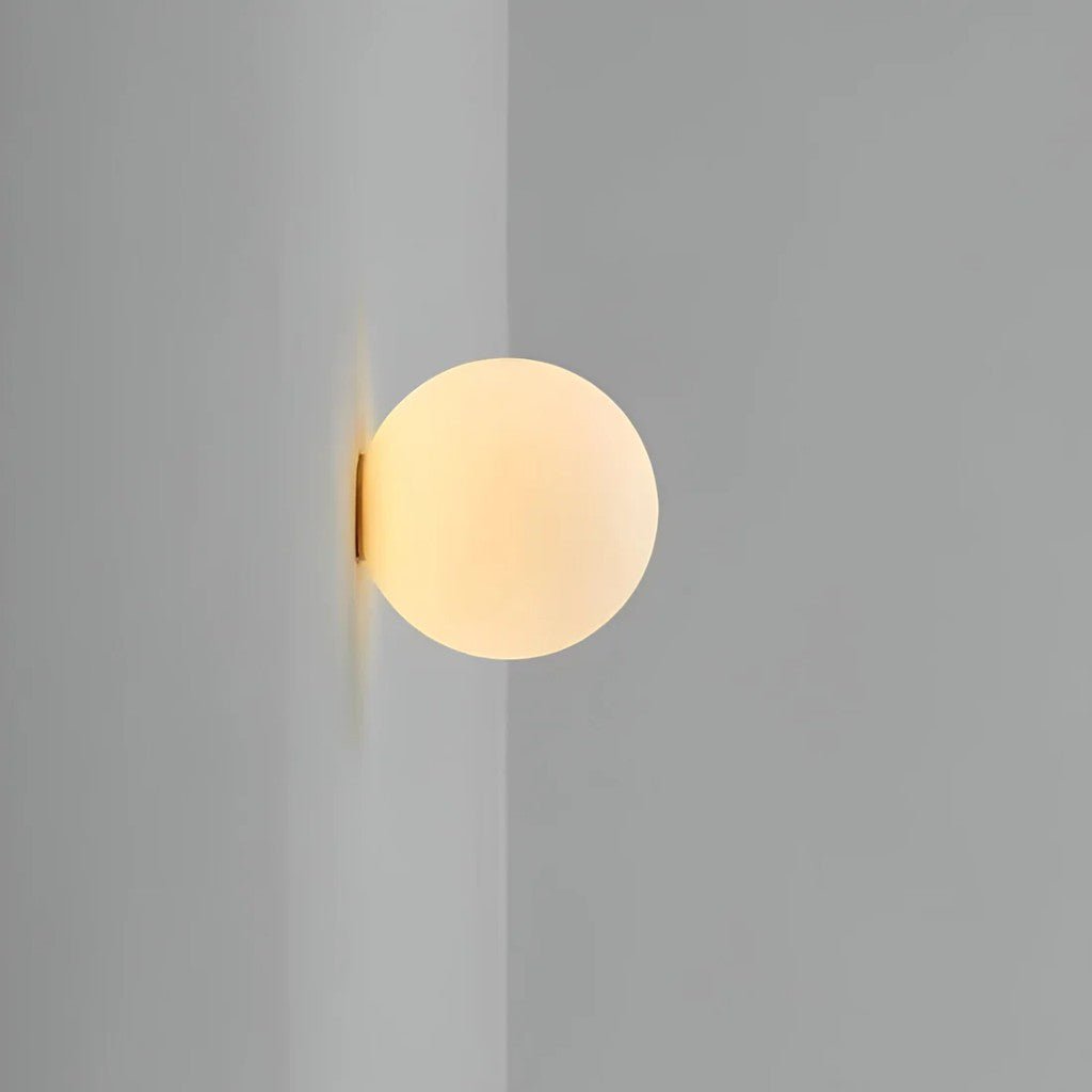 Flush mount frosted glass globe sconce highlighting seamless corner fit