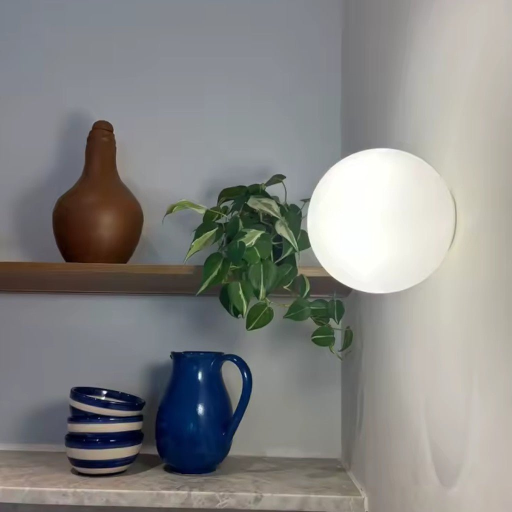 Minimalist globe wall light with concealed mount in living room setting
