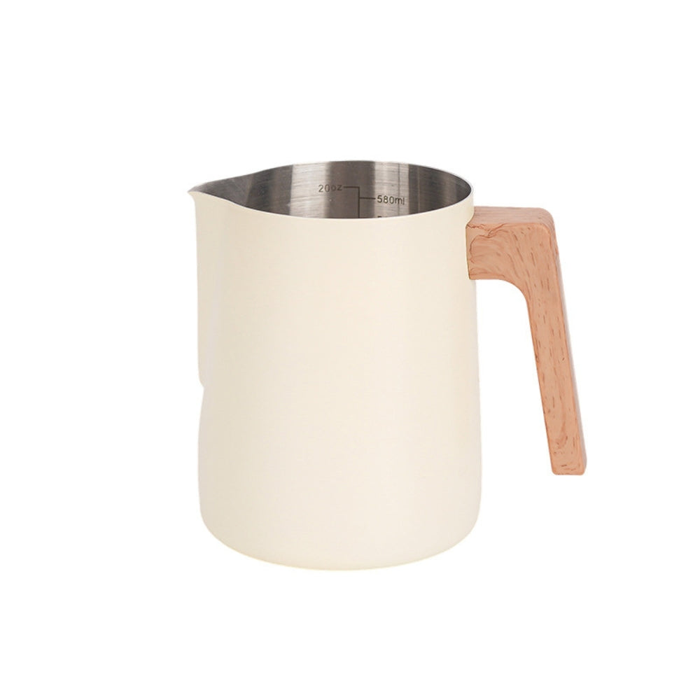 White matte barista jug with wooden handle and visible 580ml stainless steel interior markings