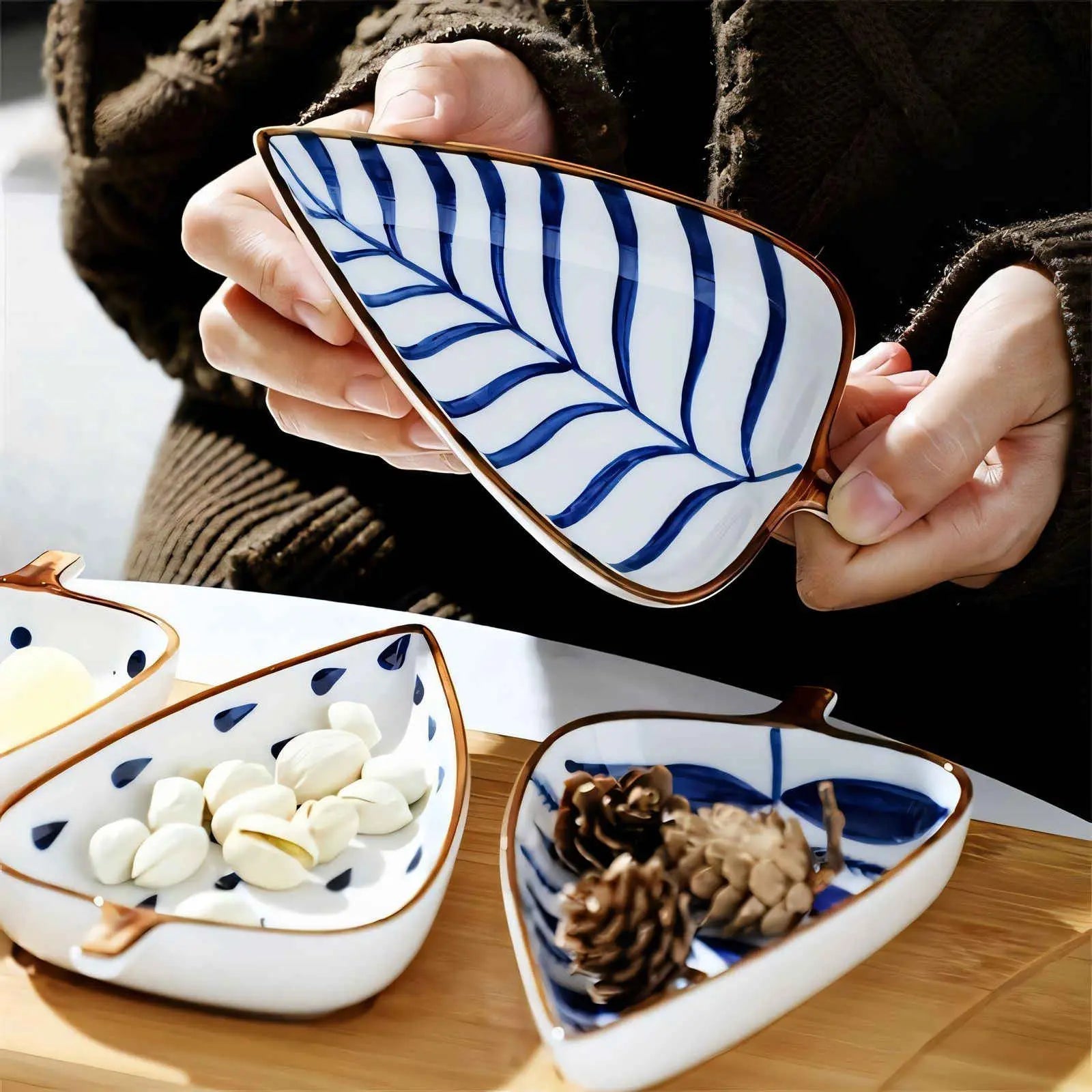 Blue vein pattern ceramic leaf plate holding garlic cloves on wooden surface
