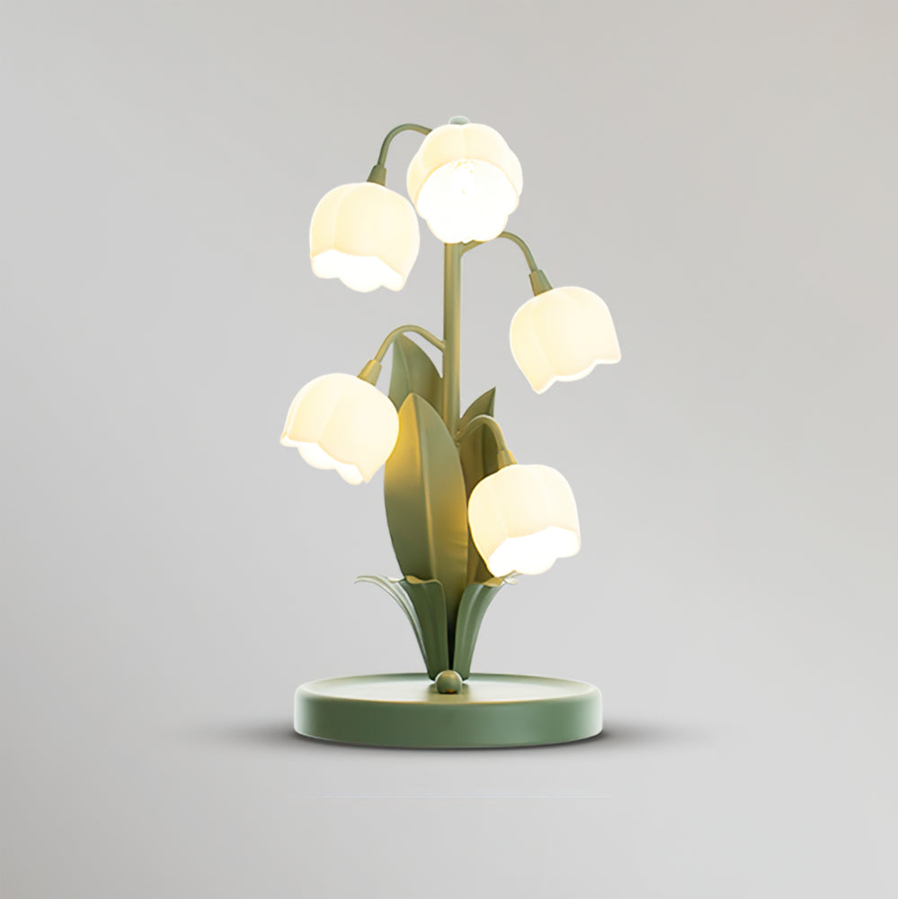 Green floral night light with glowing bell-shaped shades against neutral gray background
