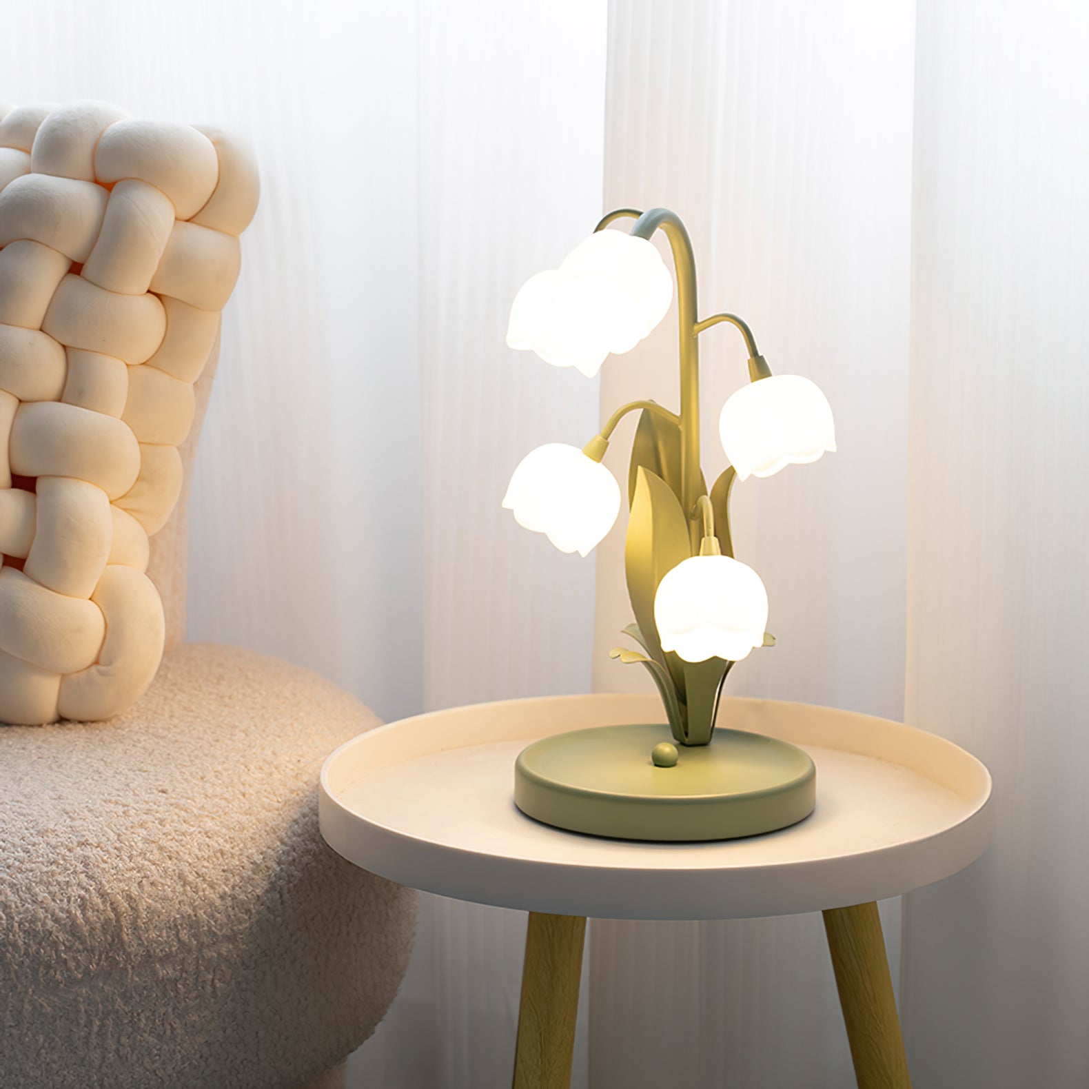 Illuminated floral bedside lamp casting warm glow on wood side table next to chair