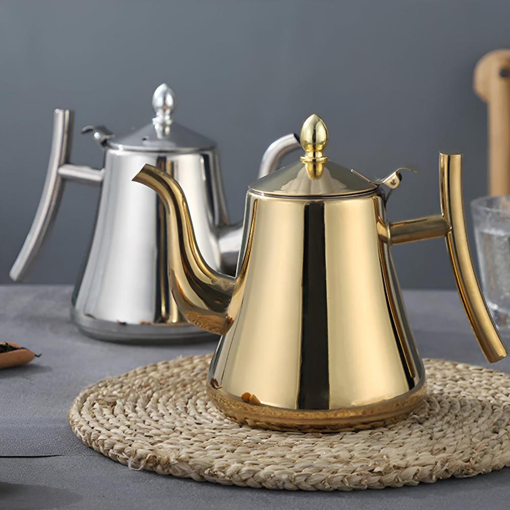 Side-by-side gold and silver stainless steel tea kettles with matching lids