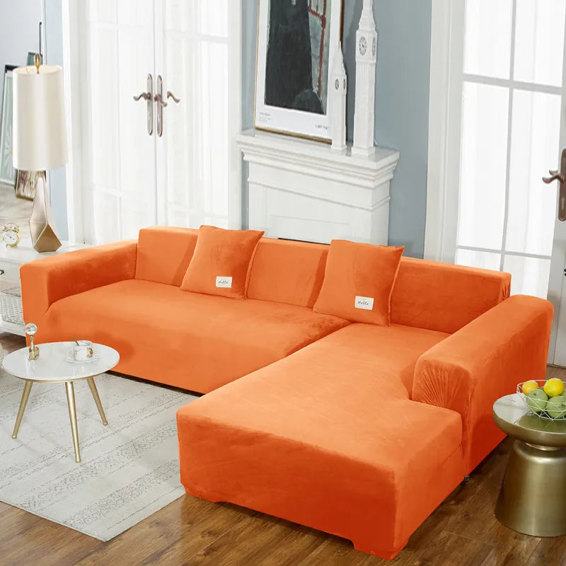 Vibrant orange stretch velvet sofa cover conforming to sectional shape