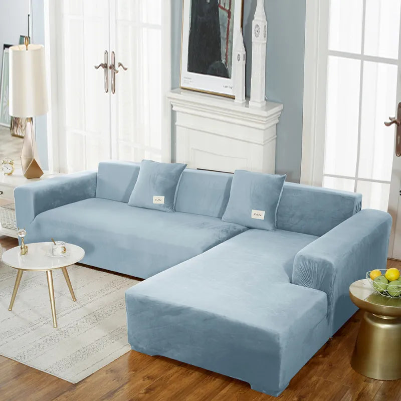 Light blue stretch velvet sofa cover on sectional with 'hello' tags
