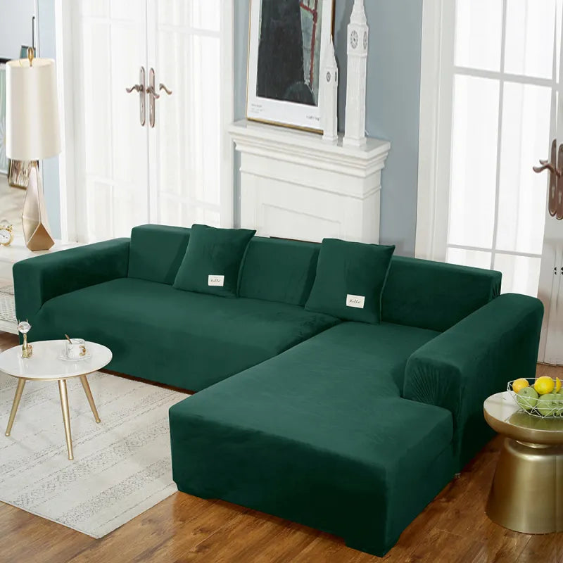 Deep green stretch velvet sofa cover on sectional with 'hello' labels