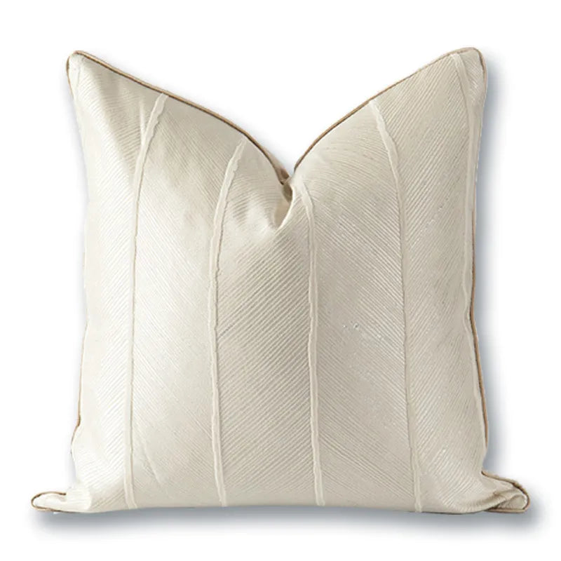 Off-white ribbed panel pillow with gold piping trim