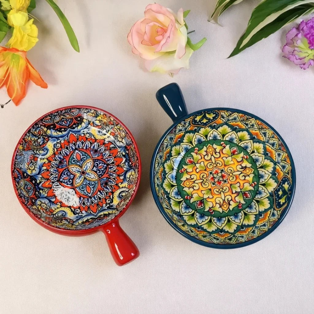 Set of two bohemian ceramic bowls with handles in red and teal displaying colorful mandala interiors