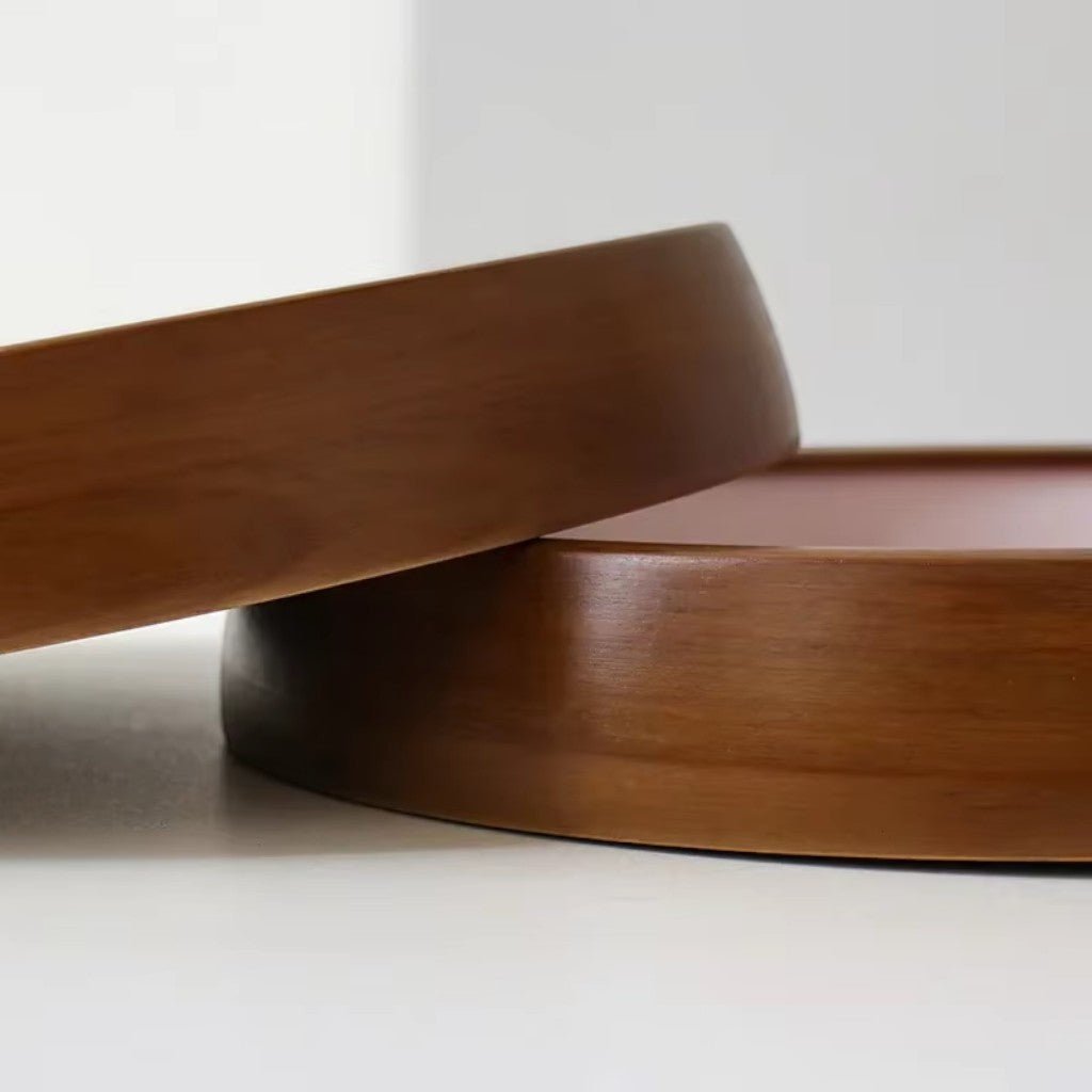 Side view of curved wooden clock components showing polished finish and grain