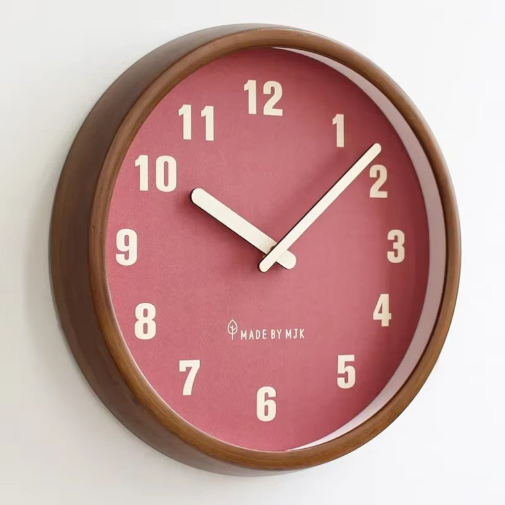 Close-up of red dial wooden wall clock with cream hands on white wall