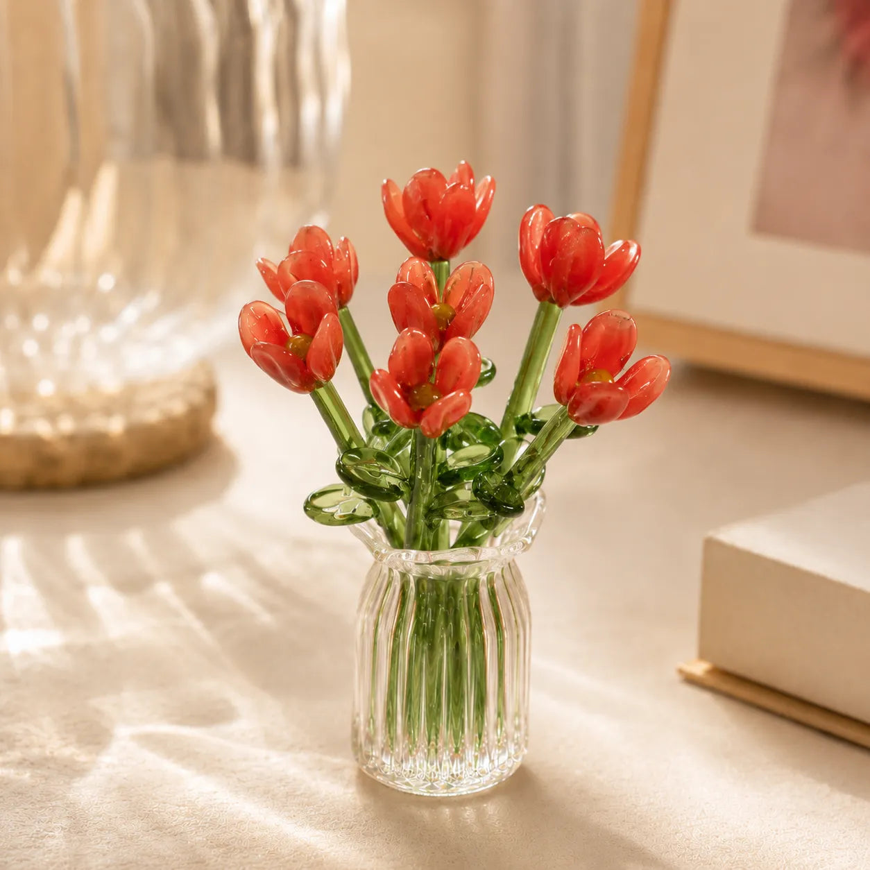 Coral-red miniature glass flower set in ribbed clear vase