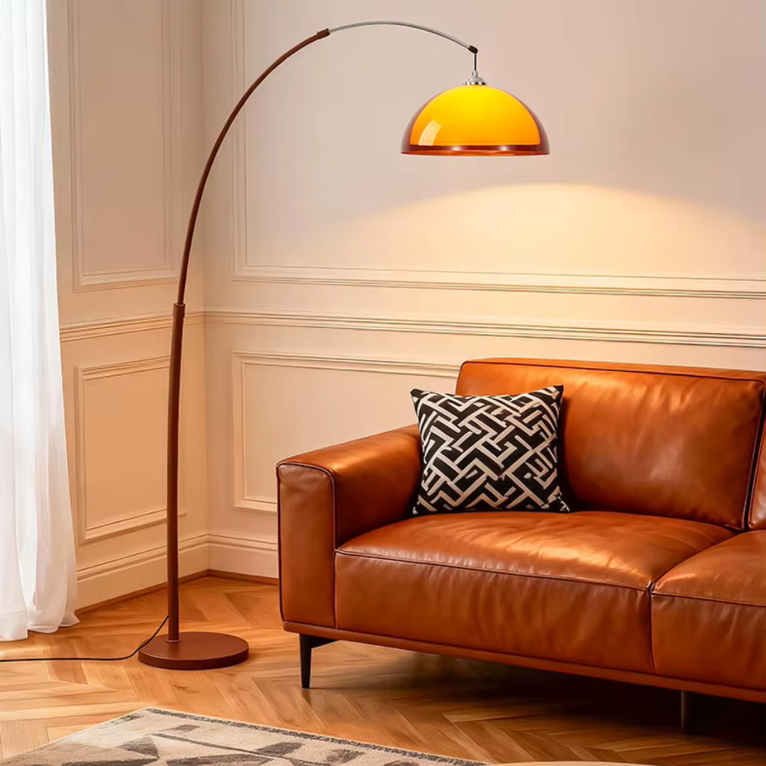 Contemporary floor lamp casting light over brown leather sofa in living room