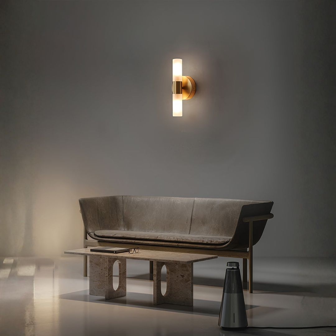 Brass up-down wall light illuminating mid-century living room space