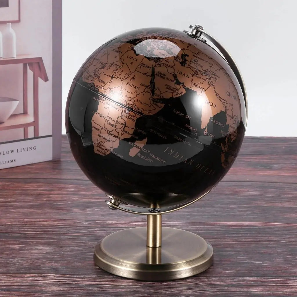 Black globe with copper continents on brass stand
