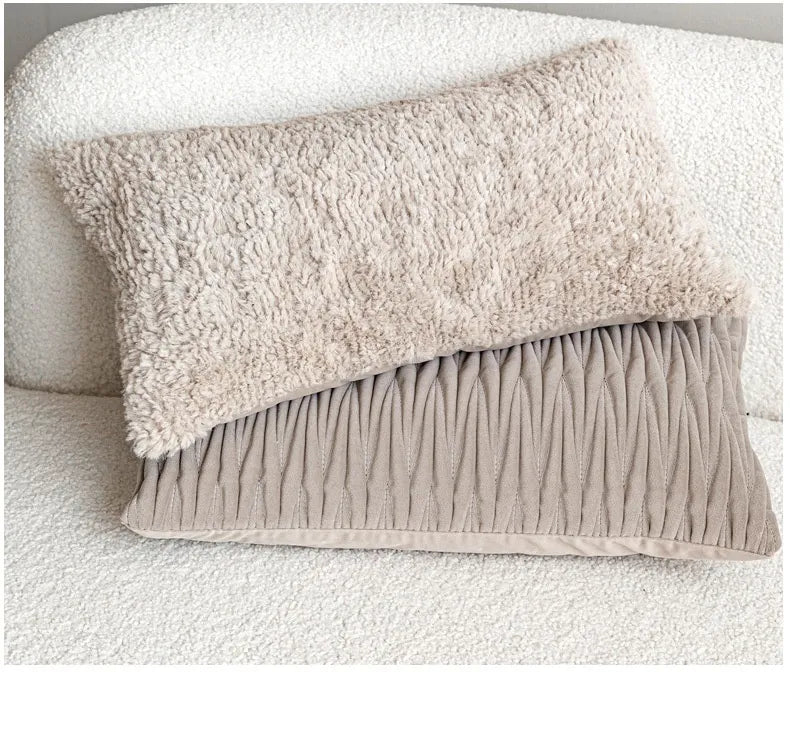 Stacked beige shaggy and taupe pleated velvet lumbar pillows