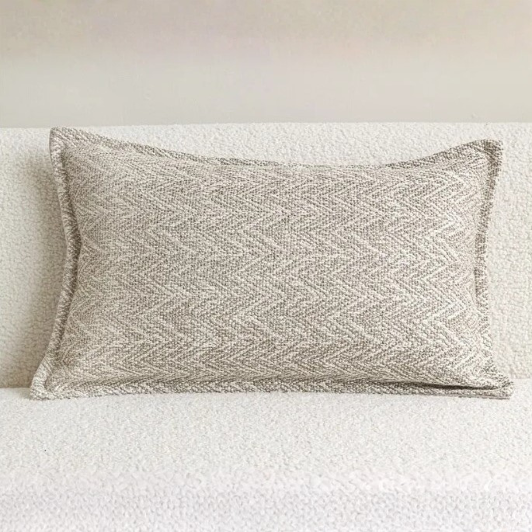 Beige herringbone weave lumbar pillow on white sofa