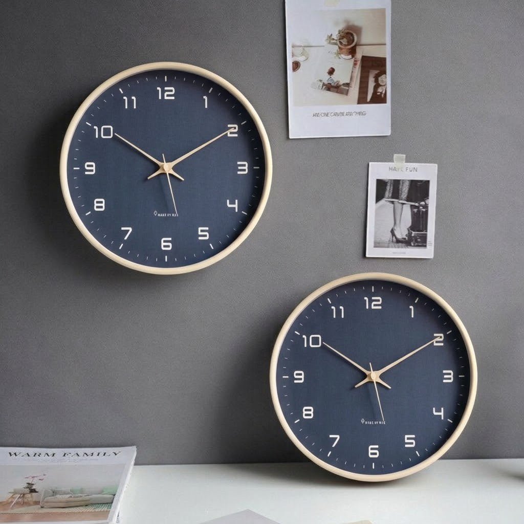 Pair of navy blue Nordic wood wall clocks with light frames on gray wall