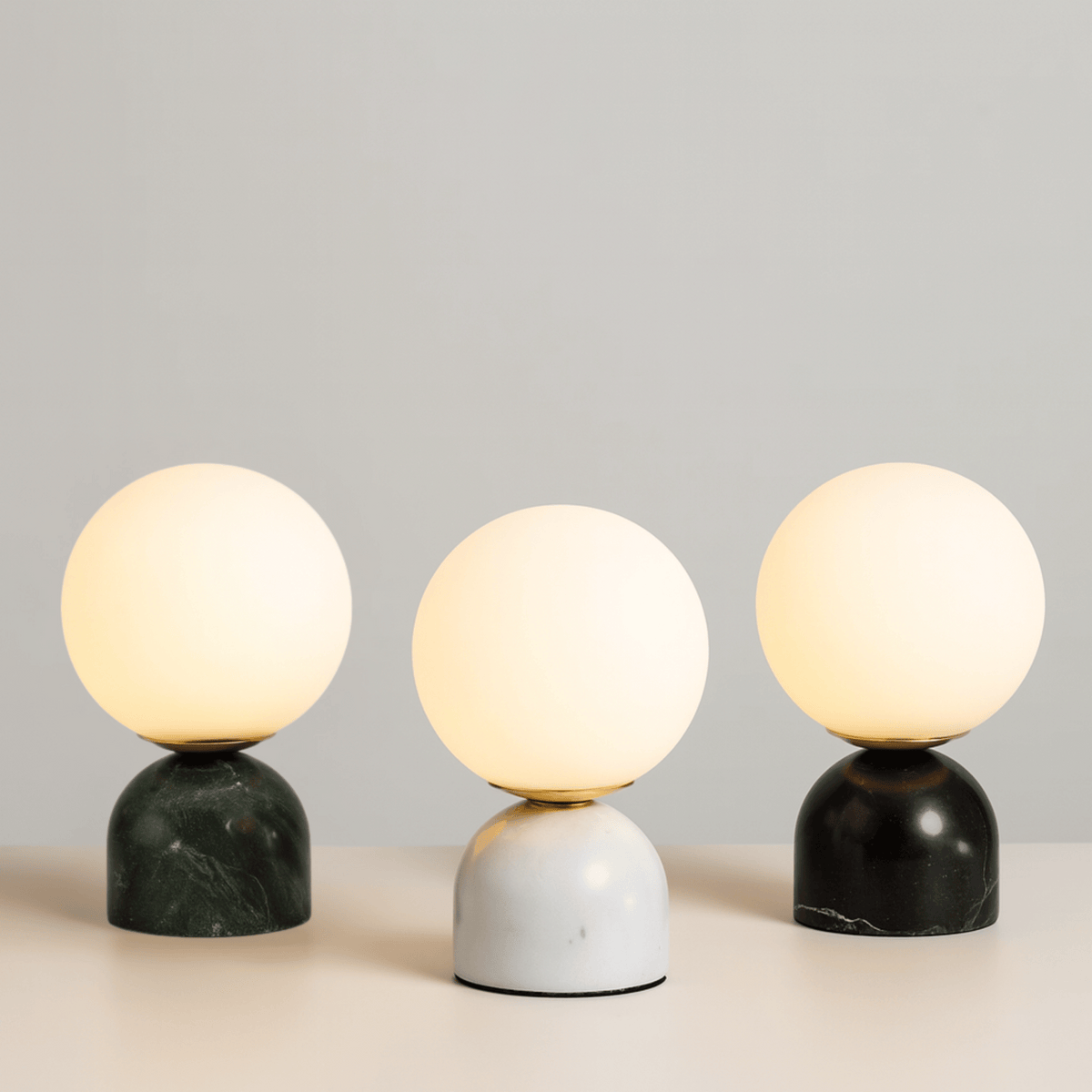 Set of three Nordic Sphere lamps in green, white, and black marble variants