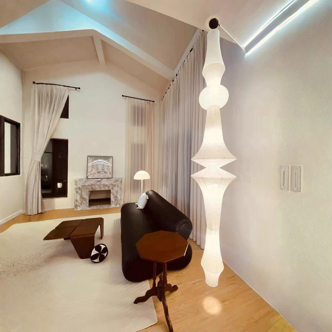 Tall white ribbed paper totem pendant light in high-ceiling living room