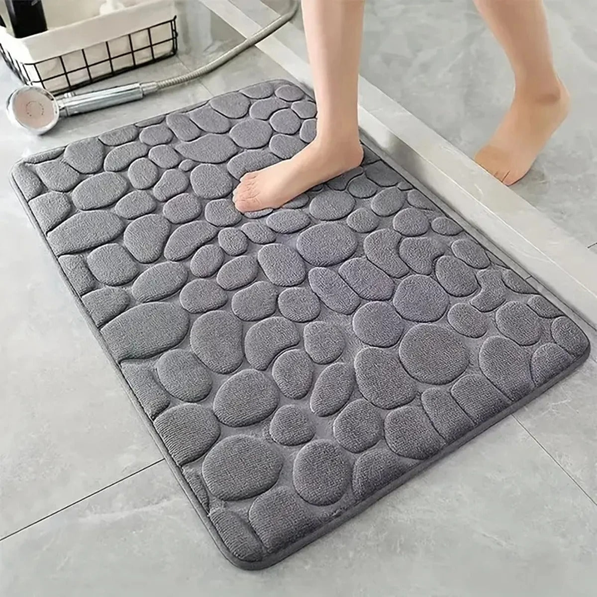 Gray textured shower mat with raised pebble design for bathroom safety